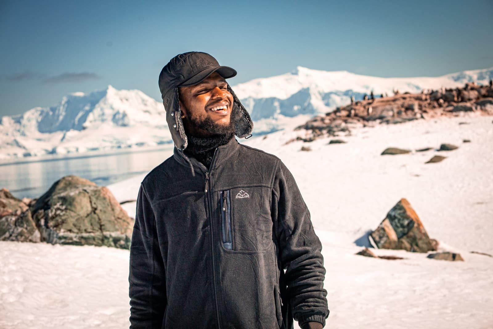 Gary A. Murray on the ice, glaciers and mountains behind him